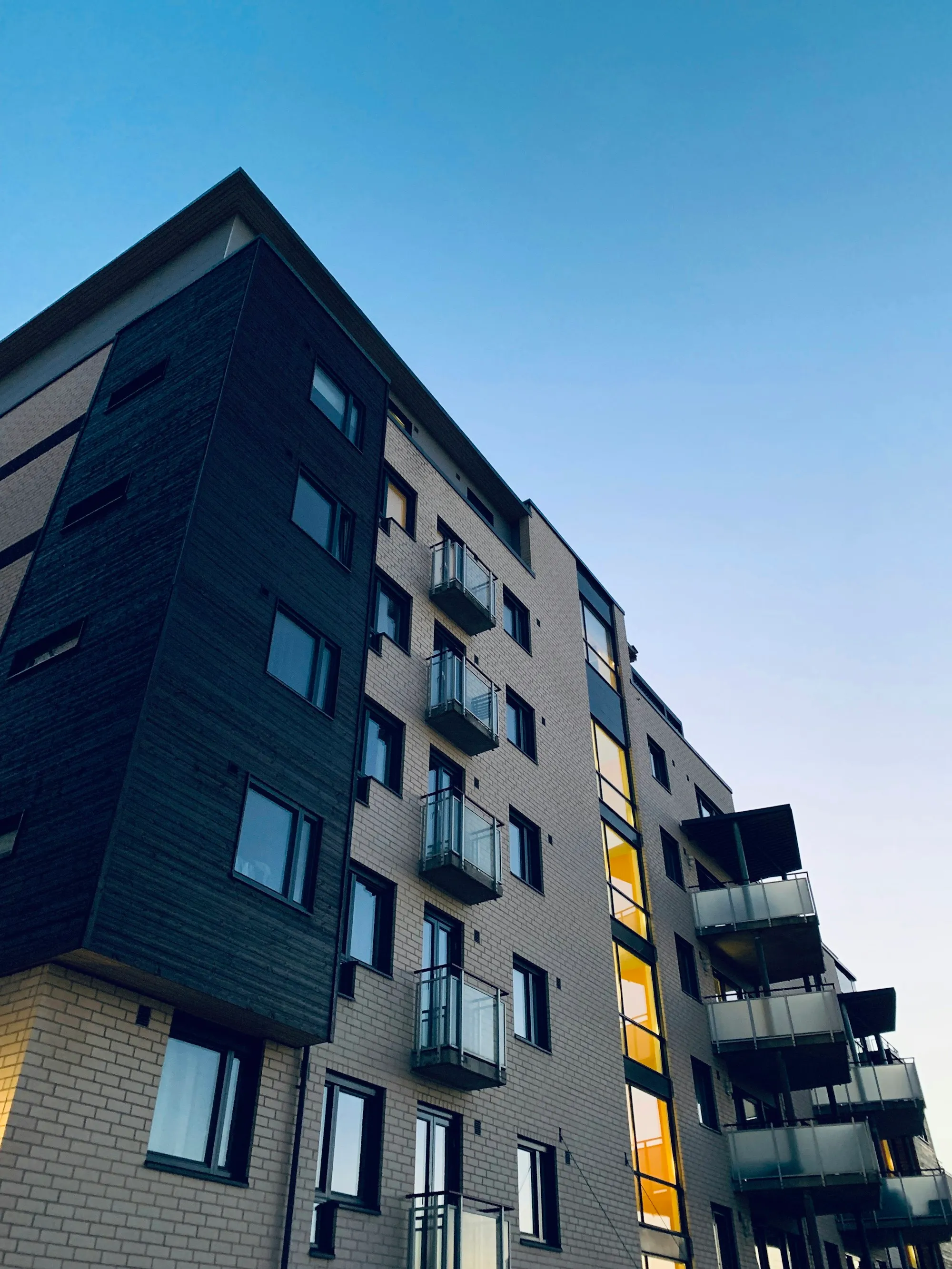 Apartment building with balconies under a clear sky