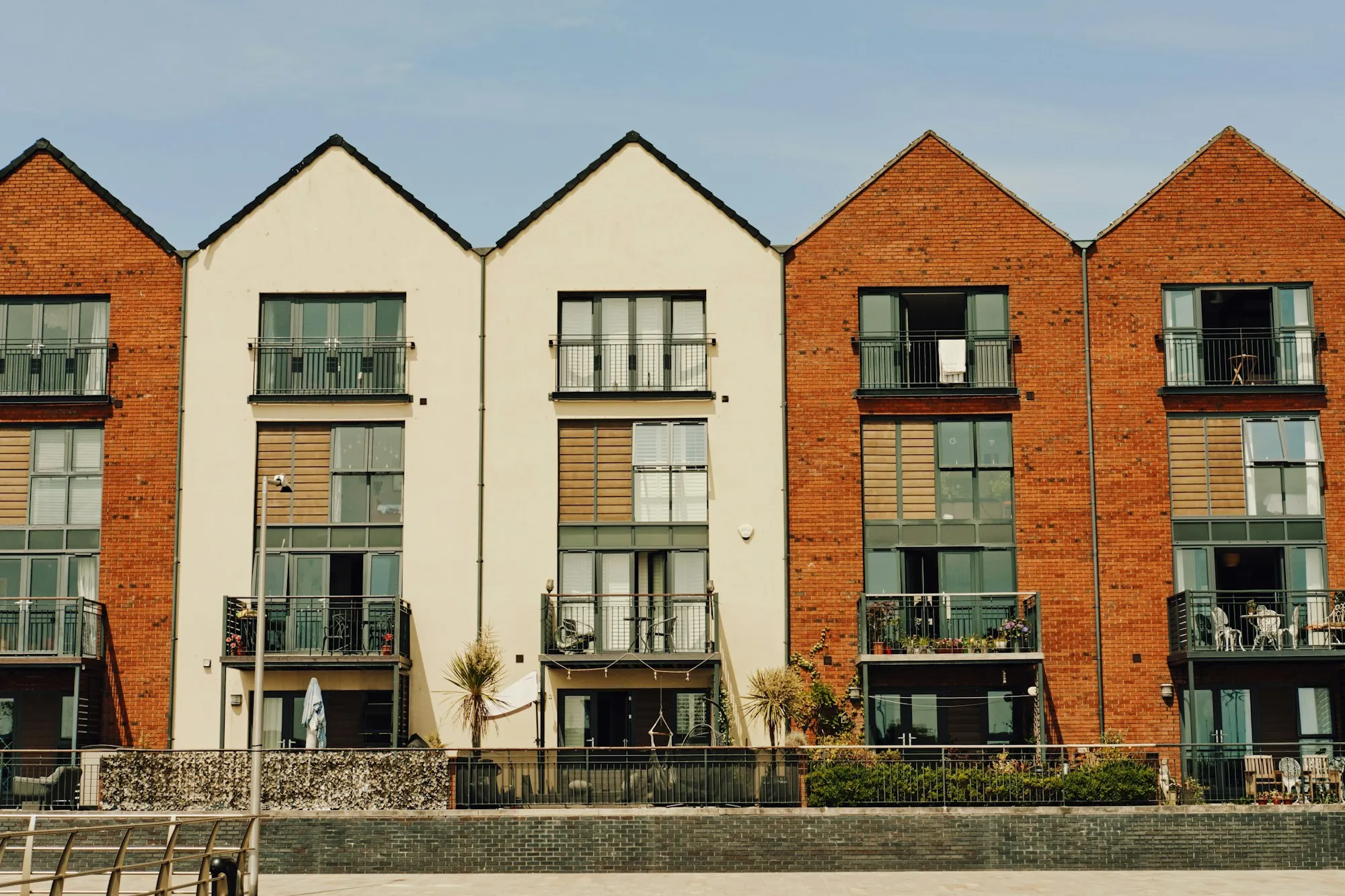 Row of modern brick and render townhouses with balconies